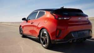 2021 Hyundai Veloster in red side shot.