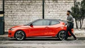 2021 Hyundai Veloster in red with man walking