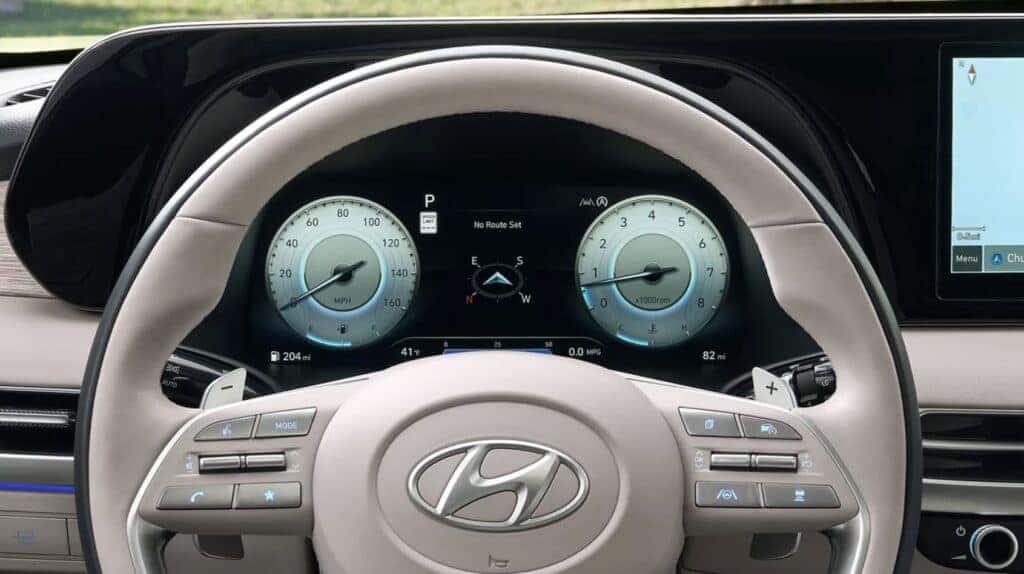 2025 Hyundai PALISADE showcasing advanced safety features, including SmartSense technology with forward collision avoidance, blind-spot monitoring, and lane-keeping assist displayed on the digital dashboard.