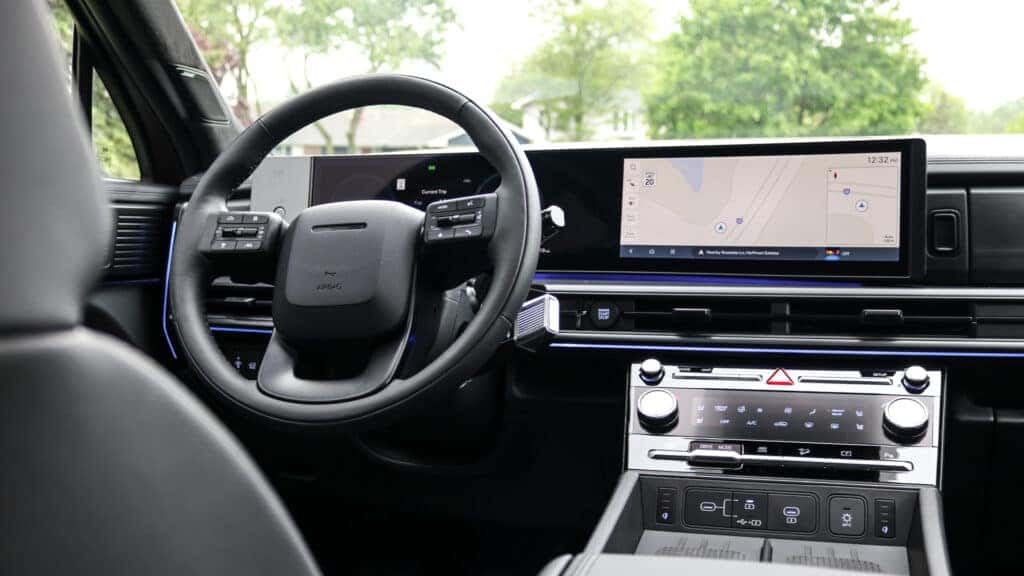 Interior of the 2025 Hyundai Santa Fe featuring a modern dashboard, wide infotainment screen, and spacious cabin layout.