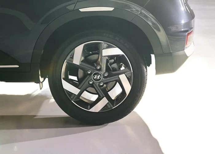 the front passenger wheel of a gray suv