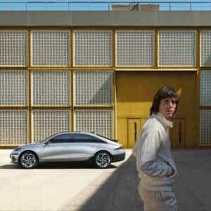 left side view of a car with a man in white shirts