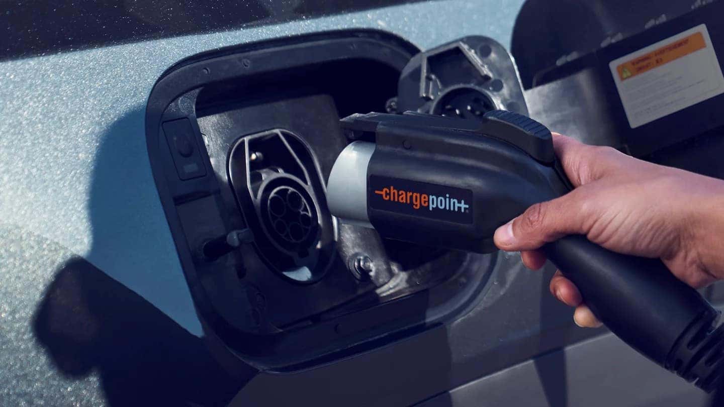 a person plugging in their 2022 tucson plug in hybrid