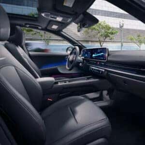 A wide-angle shot of the Hyundai Ioniq 6’s front seats, dashboard, and infotainment system, highlighting the luxurious interior design.