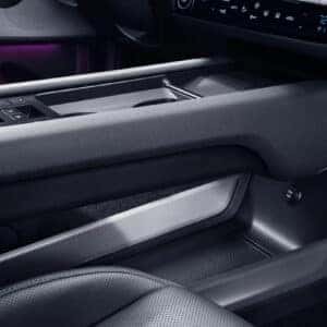 A close-up of the Hyundai Ioniq 6's center console, highlighting the ergonomic design, ambient lighting, and spacious storage compartments.