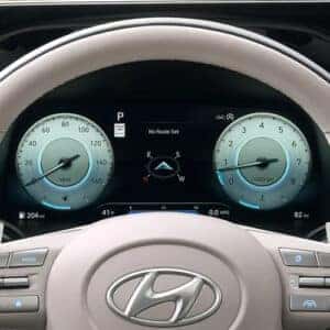 Digital instrument cluster in the 2023 Hyundai Palisade showing speedometer, fuel efficiency, and navigation directions.