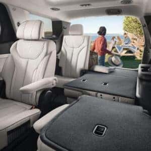Interior of the 2023 Hyundai Palisade with second-row captain’s chairs and a folded third-row, showcasing a spacious cargo area.