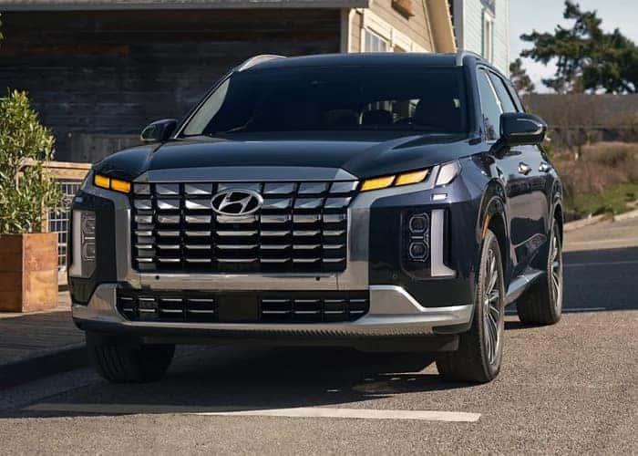 Front view of the 2023 Hyundai Palisade showcasing its bold grille and LED lighting.