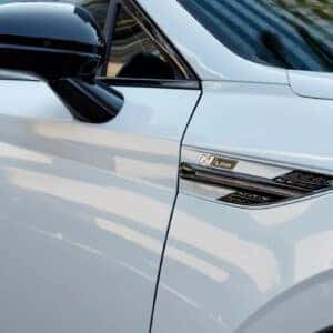 A close-up shot of the N Line badge and side vents on the front fender of the white 2024 Hyundai Sonata N Line.