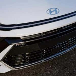 A close-up of the aggressive front grille, Hyundai logo, and black-accented headlights on the 2024 Hyundai Sonata N Line.