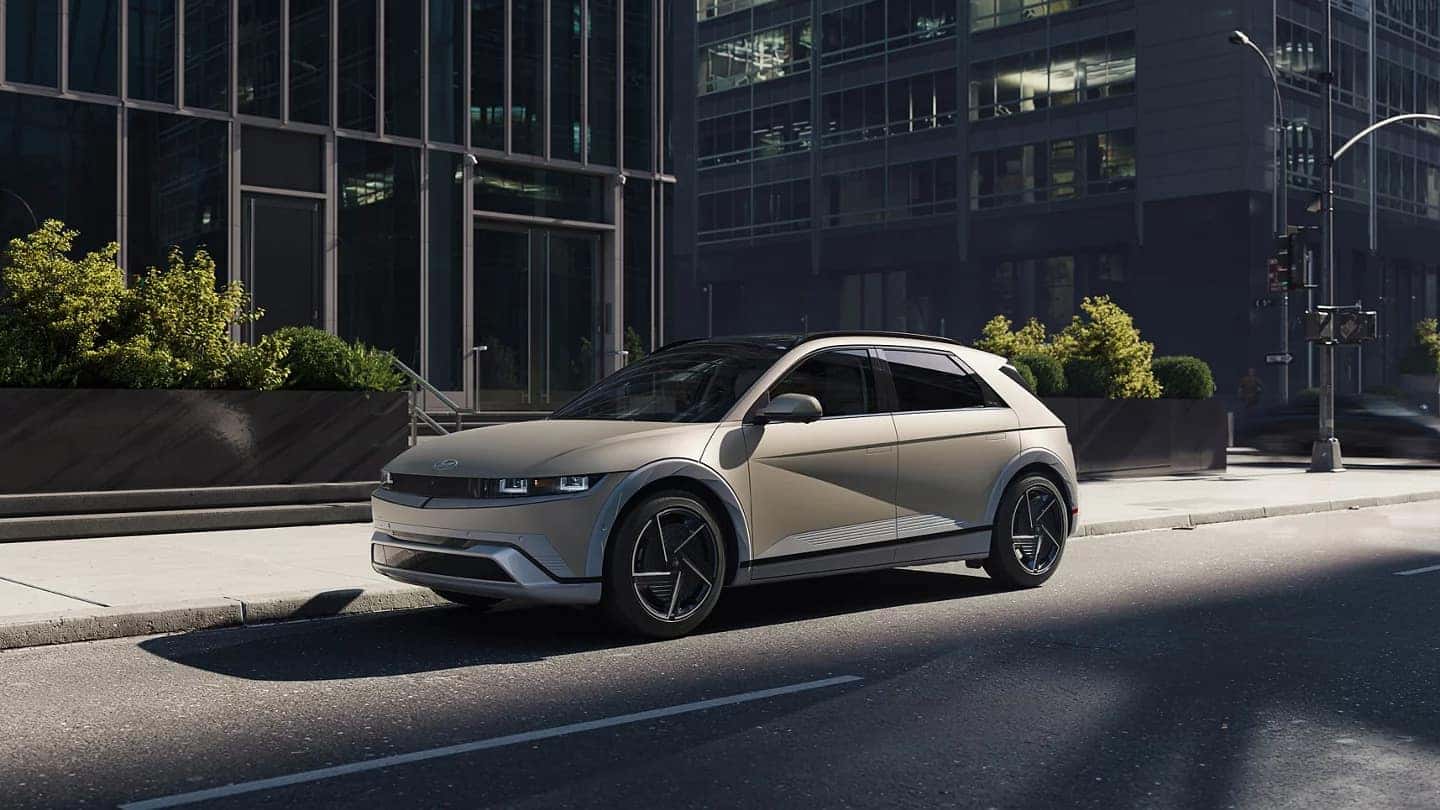 Side view of the 2025 Hyundai Ioniq 5 parked in an urban environment, showcasing its modern design and alloy wheels.