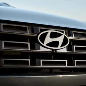 the front grille and hyundai emblem of a hyundai santa cruz