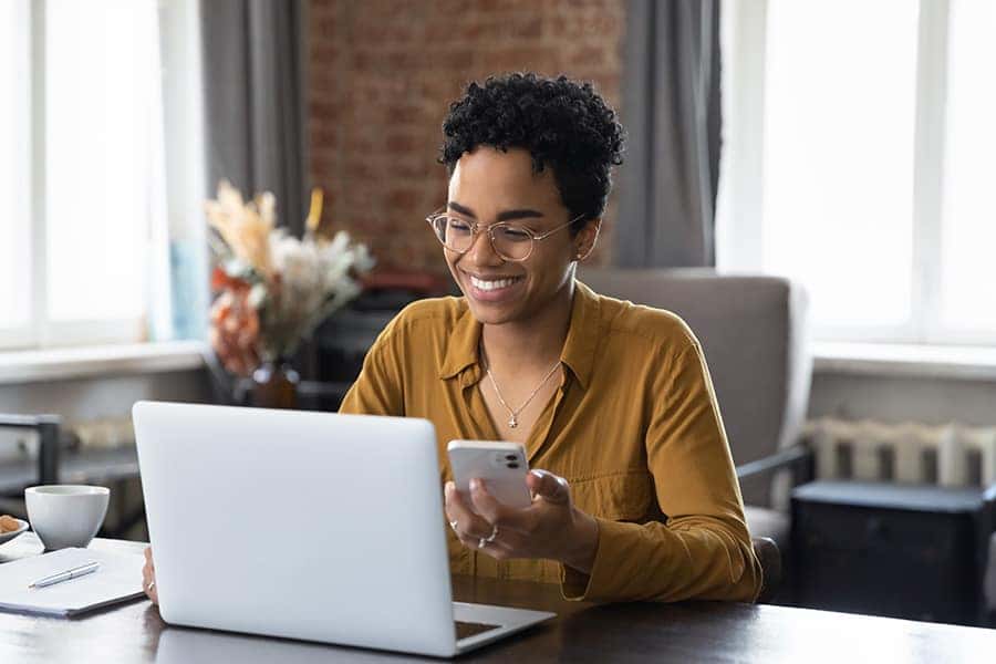 a person with their laptop and phone out. 