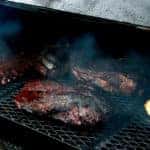 meat slow-cooking in smoker