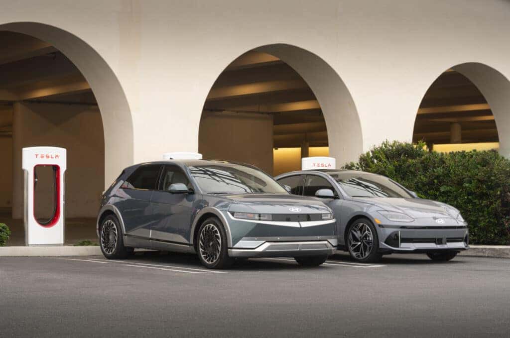 Hyundai IONIQ 5 and IONIQ 6 in front of tesla charging stations