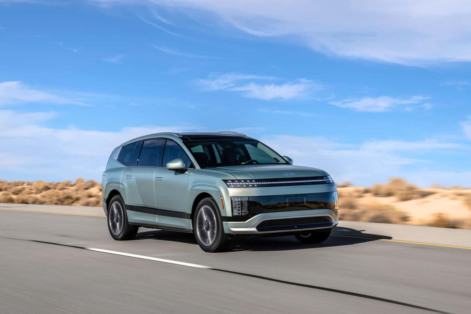 The All-New 2026 Hyundai IONIQ 9 3-ROW SUV Cruising on the highway, under crystal blue skies.