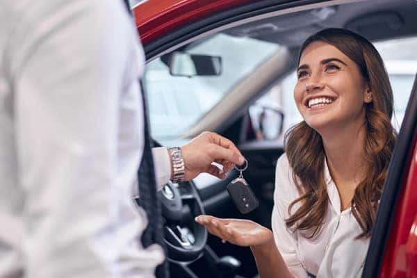 Woman getting the keys to a new car
