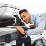 man looking at car