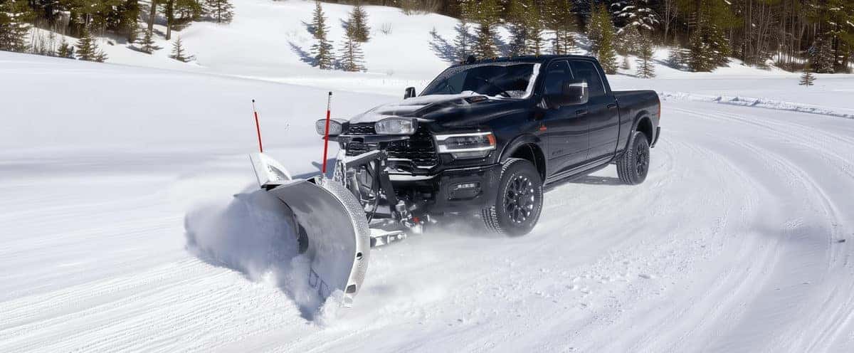 Ram 2500 with snowplow clearing a snowy road
