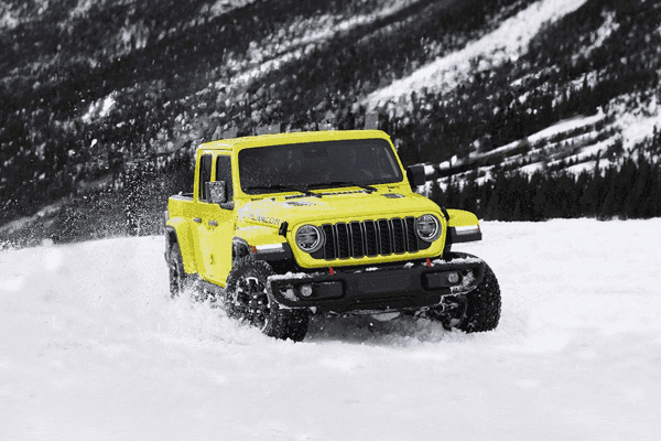 yellow jeep wrangler in snow