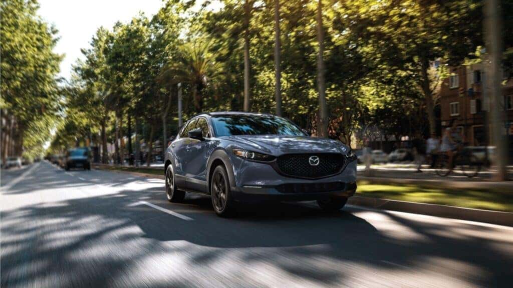 2025 Mazda CX-30 driving down a neighborhood street