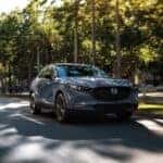 2025 Mazda CX-30 driving down a neighborhood street