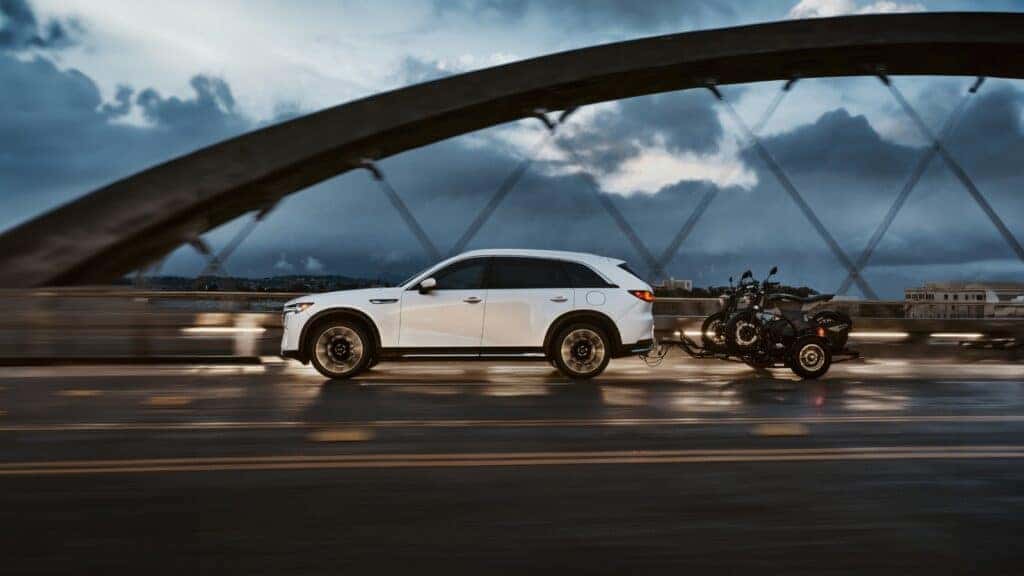 White 2025 Mazda CX-90 towing motorcycles
