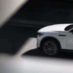 White Mazda CX-70 driving down a road