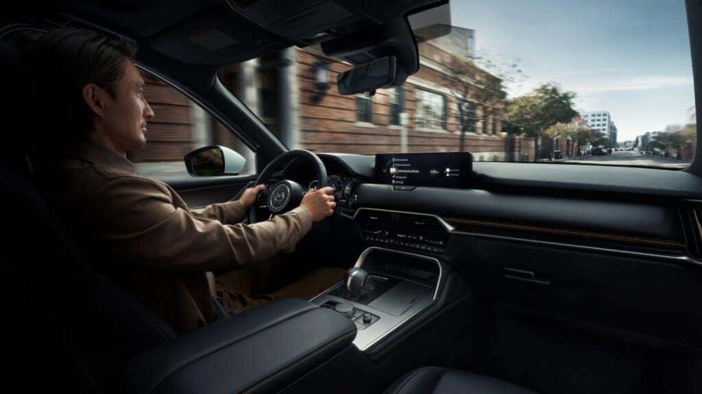 woman driving 2026 mazda cx-90