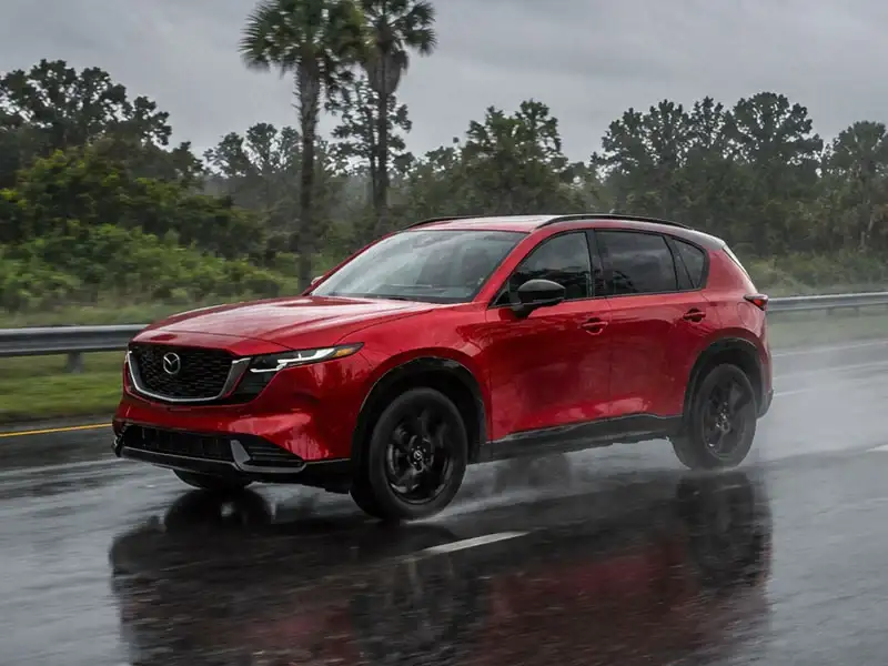 2026 Mazda CX-5 with i-Activ AWD driving on a wet road in Longwood, Florida