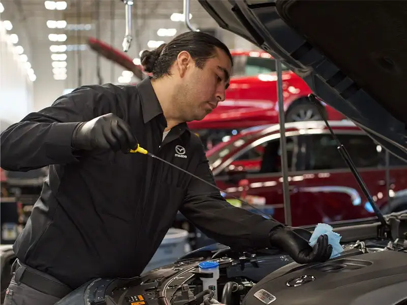 Certified Mazda technician servicing a 2026 Mazda CX-5 at the Sport Mazda North service center in Longwood, Florida