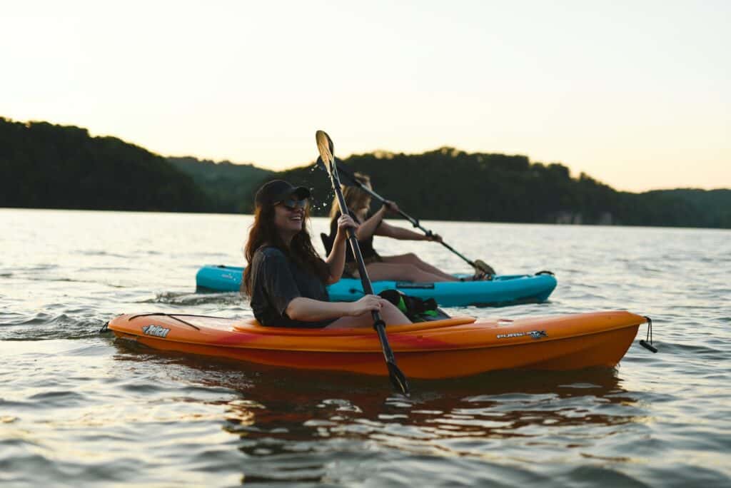 two people kayaking on water