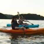 two people kayaking on water