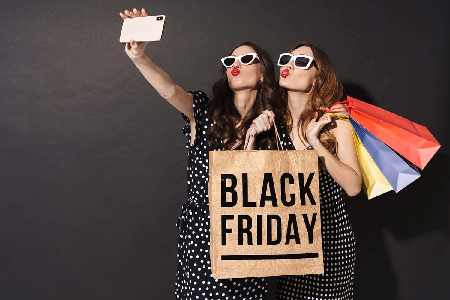 Two women are clicking selfies with a Black Friday Sale in St. George, UT
