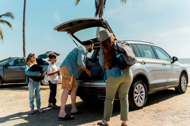 Family loading luggage into an SUV, demonstrating practical cargo space