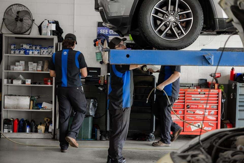 Service technicians working on a vehicle in the Fond du Lac dealership service department.
