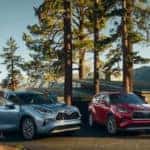 Toyota Highlander models parked near cabin