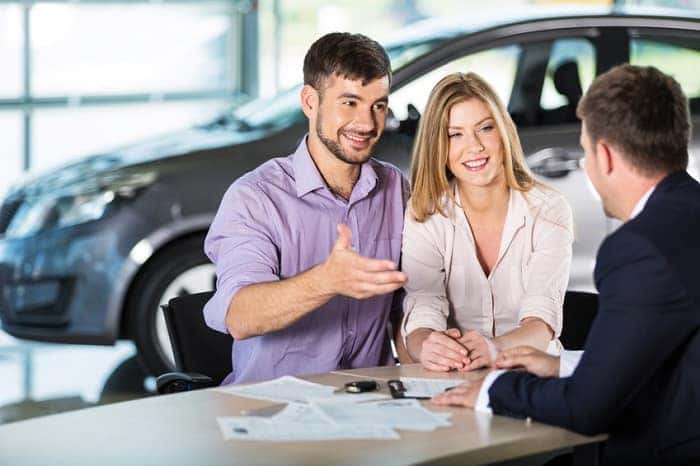 making a deal at car dealership